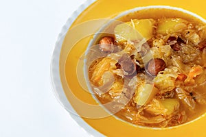 Cabbage soup in yellow plate