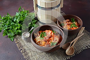 Cabbage stew with grilled sausage in tomato sauce -