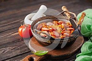 Cabbage stew with grilled sausage in tomato sauce