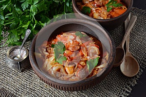 Cabbage stew with grilled sausage in tomato sauce -