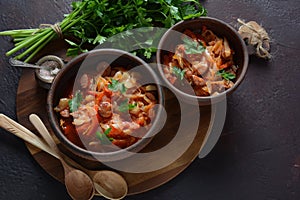 Cabbage stew with grilled sausage in tomato sauce