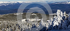 Cabeza de Manzaneda ski resort covered in snow among pine trees on a sunny day photo