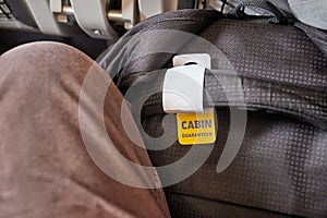 Cabin bag in front of seat on economy class flight