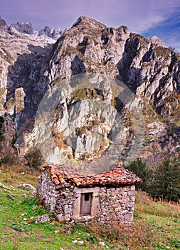 Cabin and Central Massif in background seen from El Arcediano track, Picos de Europa National Park and Biosphere Reserve, Asturias photo