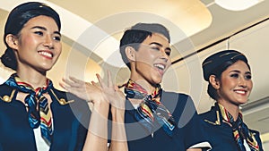 Cabin crew dancing with joy in airplane