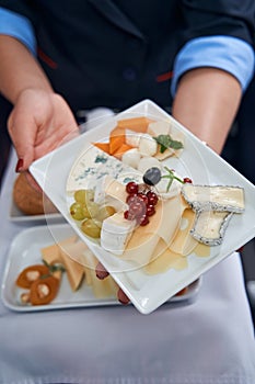 Cabin crew member showing food to camera