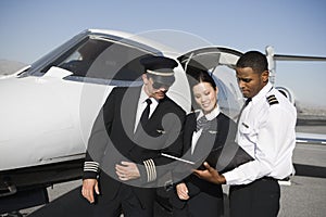 Cabin Crew Members Discussing Reports Together