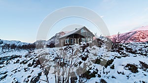 Cabin in front of frozen landscape in Norway
