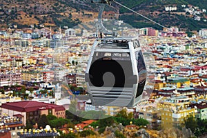 Cabin hanging above the houses of the city on the cableway