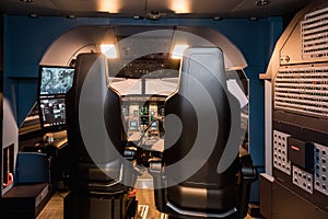 Cabin of a large airliner simulator. View of the cockpit and seats in the A320 airbus simulator