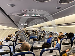 Cabin of a modern airplane filled with passangers