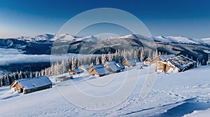 Cabin in the mountains in winter. Mysterious fog. In anticipatio