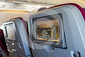 Cabin with people aboard looking at LCD monitors.