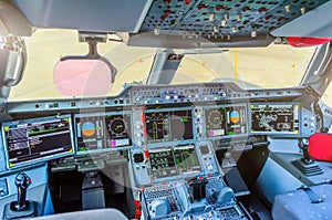 Cabin pilots aircraft view of the windshield, steering wheels, control devices.