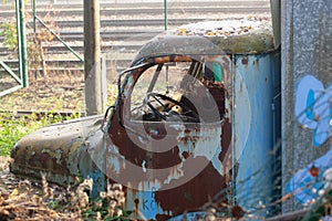 The cabin and the steering wheel of an old abandoned and rusty truck