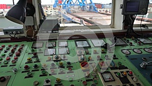 Cabin to control the crane. View from the crane operator working place. Gantry crane operator moving a sea container