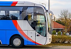 The cabin of a white, red and blue modern tour bus, transport for the travel industry
