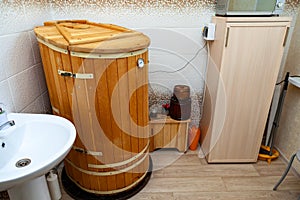 Cabinet for cosmetology procedures, rest and recovery with wooden phyto barrels for spa, wellness and skin care and human figure.