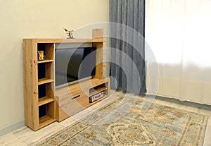 Cabinet-stand with TV in the interior of the living room