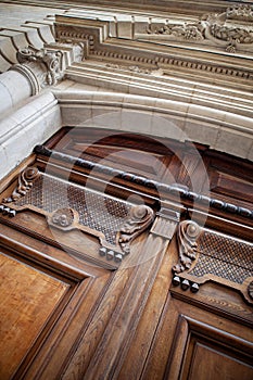 Cabinetmaker work at the entrance of a stone mansion