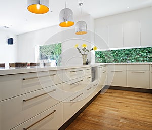 Cabinetry drawers in a new contemporary white kitchen renovation photo