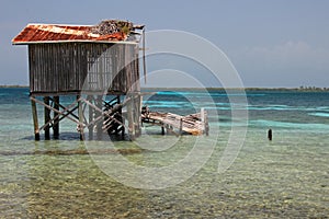 Cabins on stilts on the small island of Tobacco Caye, Belize