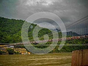 Cable bridge over ganga river in rishikesh india. Ropeway bridge on the ganga river photo