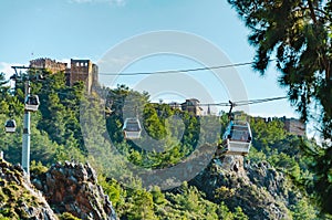 Cable car against sky. Two ficicular cabins transport tourists to the mountains