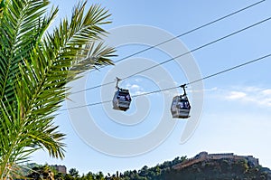 Cable car against sky. Two ficicular cabins transport tourists to the mountains