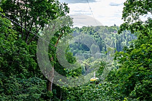 cable car crossing valley of Gauja in Sigulda, Latvia in green summer