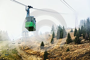 Cable car descending thorugh the fog from the peak