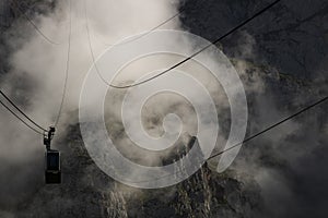 Cable car among the fog in Fuente De photo