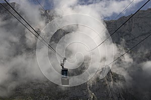 Cable car in front of a foggy mountain photo