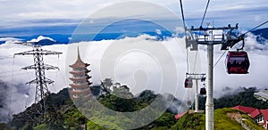 Cable car at genting highlands, malaysia in a foggy weather with chin swe chinese temple visible from inside cable car