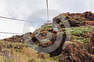 Cable car going to the beach of Garajau, Canico, Madeira island, Portugal, Europe. Panoramic view of majestic coastal cliff