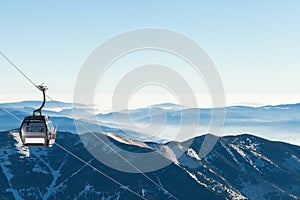 Cable car going up the mountain with beautiful scenery on background