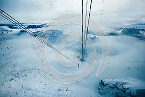 Cable car isolated on white background in foggy mountains