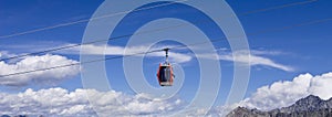 A cable car in the mountains on the italian Alps above clouds Trentino, Italy