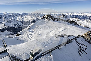 Cable car in the mountains. Snowy winter mountain background.