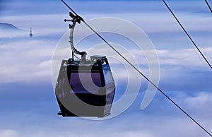 Cable car over city covered by pollution and smog