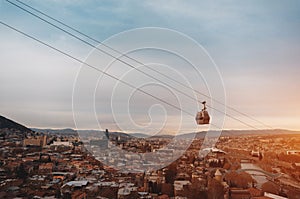 cable car rope way over Georgian capital Tbilisi, aerial of historical district