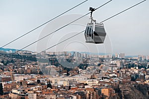 cable car rope way over Georgian capital Tbilisi, aerial of historical district