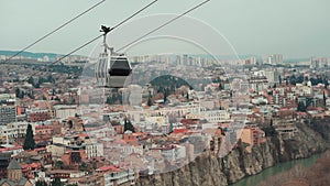 cable car rope way over Georgian capital Tbilisi, aerial of historical district