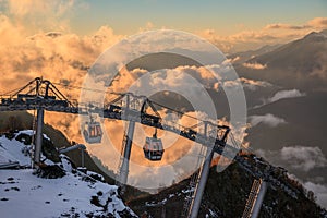 Cable car ski lifts in Gorky Gorod mountain ski resort can. Beautiful scenic sunset landscape. Sochi, Russia, Caucasus