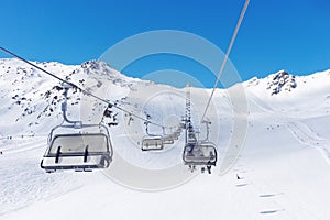 Cable car at a ski resort. Skiers ascend the mountain in the chair lift