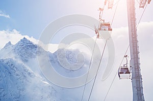 Cable car on the ski resort and snow-covered mountains