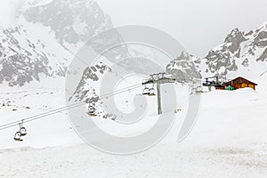 Cable car in the snowy mountains in cloudy weather