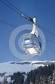 Cable car with specs of snow