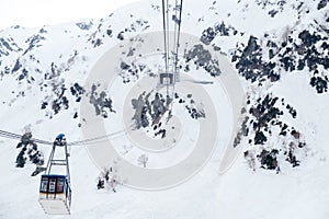 Cable car at Tateyama Kurobe Alpine Snow mountain,repairman or maintenance man on top of airline cable rope way,dangerous working