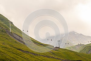 Cable cars int the northern mountains of Georgia on foggy day connecting towns with ski reports near Stepantsminda near Russia